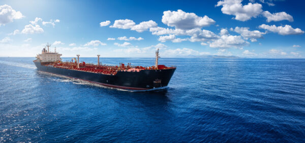 A chemical goods or crude oil tanker sailing with speed over the blue Ocean with copy space