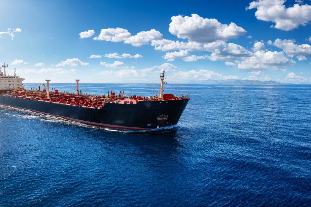 A chemical goods or crude oil tanker sailing with speed over the blue Ocean with copy space